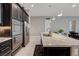 Open-concept kitchen with large island, stainless appliances, dark wood cabinets, and an open view to dining at 4523 Herbert River Ave, Las Vegas, NV 89141