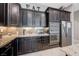Well-appointed kitchen featuring stainless steel appliances, granite counters, and dark wood cabinetry at 4523 Herbert River Ave, Las Vegas, NV 89141