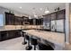 Well-appointed kitchen features granite island, stainless appliances, and stylish dark cabinetry at 4523 Herbert River Ave, Las Vegas, NV 89141
