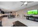 Open-concept living space with tile floors, television, and a view of the kitchen and dining area at 4523 Herbert River Ave, Las Vegas, NV 89141