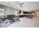 Open-concept living space with tile floors, comfortable seating, and a view of the kitchen and dining area at 4523 Herbert River Ave, Las Vegas, NV 89141