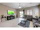 Bright living room with tile flooring, large television, and access to the outdoor pool area at 4523 Herbert River Ave, Las Vegas, NV 89141