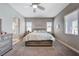 Comfortable bedroom with ceiling fan, carpet flooring, natural light, and an ensuite bathroom at 4523 Herbert River Ave, Las Vegas, NV 89141