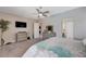 Spacious main bedroom featuring plush carpet, ceiling fan, and ensuite access at 4523 Herbert River Ave, Las Vegas, NV 89141