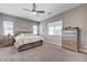 Comfortable bedroom with ceiling fan, carpet flooring, natural light, and matching dresser at 4523 Herbert River Ave, Las Vegas, NV 89141