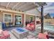 Covered patio area with a built-in fire pit, seating, and views of the pool and backyard at 4523 Herbert River Ave, Las Vegas, NV 89141