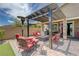 Cozy covered patio featuring comfortable seating, a fire pit, and a relaxing outdoor ambiance at 4523 Herbert River Ave, Las Vegas, NV 89141
