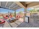 Beautiful outdoor patio featuring a built-in grill, seating, and fire pit at 4523 Herbert River Ave, Las Vegas, NV 89141