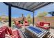 Inviting covered patio with a fire pit and comfortable seating arrangement for outdoor enjoyment at 4523 Herbert River Ave, Las Vegas, NV 89141