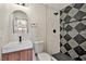 Modern bathroom with walk-in shower, stylish black and white tile, and a floating vanity at 5004 Celebrity Cir, Las Vegas, NV 89119