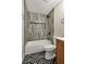 Bathroom featuring chevron floors, tiled shower with niche, black fixtures, and new toilet at 5004 Celebrity Cir, Las Vegas, NV 89119