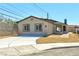 A charming home features a freshly poured driveway, low maintenance landscaping, and inviting curb appeal at 5004 Celebrity Cir, Las Vegas, NV 89119