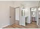 Hallway featuring wood floors, views of a vanity, and access to the bathroom at 5004 Celebrity Cir, Las Vegas, NV 89119