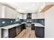 Charming kitchen with white countertops, black cabinetry, tile backsplash, and stainless steel appliances at 5004 Celebrity Cir, Las Vegas, NV 89119