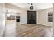 Open-concept floor plan showcasing the living room and kitchen, with stylish wood-look flooring at 5004 Celebrity Cir, Las Vegas, NV 89119