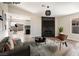 Inviting living room with modern furnishings, fireplace with stylish black tile and wood-look flooring at 5004 Celebrity Cir, Las Vegas, NV 89119