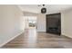 Spacious living area featuring wood-look flooring and an elegant fireplace with black herringbone tile at 5004 Celebrity Cir, Las Vegas, NV 89119