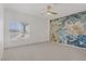 Relaxing bedroom with a ceiling fan and a unique, decorative wall at 5112 Harvest Time St # 201, Las Vegas, NV 89130