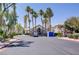 Community clubhouse with palm trees, green landscaping, and ample parking at 5112 Harvest Time St # 201, Las Vegas, NV 89130