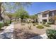 Beautiful community grounds featuring decorative rock and mature trees at 5112 Harvest Time St # 201, Las Vegas, NV 89130