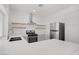 Modern kitchen featuring white cabinets, quartz countertops, and stainless appliances at 5112 Harvest Time St # 201, Las Vegas, NV 89130