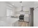 Updated kitchen with white cabinets, stainless steel appliances, and island at 5112 Harvest Time St # 201, Las Vegas, NV 89130