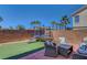 Entertainer's backyard featuring manicured synthetic grass, a trampoline, and outdoor seating at 554 Haunts Walk Ave, Las Vegas, NV 89178
