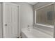 Clean bathroom featuring a bathtub with marble surround and a window for natural light at 554 Haunts Walk Ave, Las Vegas, NV 89178