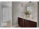 Well-lit bathroom with double sink vanity, wood cabinets, and separate bathtub and toilet room at 554 Haunts Walk Ave, Las Vegas, NV 89178