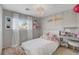 Charming bedroom with decorative lighting, playful decor, and natural light at 554 Haunts Walk Ave, Las Vegas, NV 89178