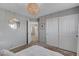 Bright bedroom with mirrored accent wall, chandelier lighting, and access to the hallway at 554 Haunts Walk Ave, Las Vegas, NV 89178