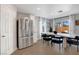 Modern kitchen features stainless steel appliances, wood-look tile, and sliding glass door to the backyard at 554 Haunts Walk Ave, Las Vegas, NV 89178