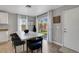 Bright kitchen with light cabinets, table with seating, and sliding glass door to the backyard at 554 Haunts Walk Ave, Las Vegas, NV 89178