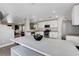 Open kitchen showcasing stainless steel appliances, granite counters, and spacious island with seating at 554 Haunts Walk Ave, Las Vegas, NV 89178