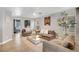 Cozy living room featuring comfortable seating and a stylish decorative tree at 554 Haunts Walk Ave, Las Vegas, NV 89178