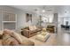Comfortable living room with plush sofas, a ceiling fan, and an open layout to kitchen at 554 Haunts Walk Ave, Las Vegas, NV 89178