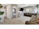 Inviting living room with comfortable sectional sofa, plush rug, and access to bathroom and bedroom at 554 Haunts Walk Ave, Las Vegas, NV 89178