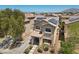 Stunning aerial view of a home with solar panels, lush landscaping, and a welcoming front entrance at 5656 Fast Payout Ct, Las Vegas, NV 89122