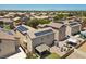 Aerial view of home with solar panels, covered patio, hardscaped backyard, and a detached garage at 5656 Fast Payout Ct, Las Vegas, NV 89122