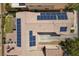 Aerial view of a house with solar panels installed on the roof and a patio area with outdoor furniture at 5656 Fast Payout Ct, Las Vegas, NV 89122