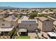 Backyard aerial view featuring solar panels, a covered patio, and an expansive backyard in a residential neighborhood at 5656 Fast Payout Ct, Las Vegas, NV 89122