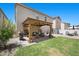 Spacious backyard with covered patio, lush lawn, and brick-paved area perfect for outdoor enjoyment at 5656 Fast Payout Ct, Las Vegas, NV 89122
