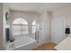 Bathroom with a bathtub, separate shower, and a window providing natural light at 5656 Fast Payout Ct, Las Vegas, NV 89122