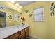 Bathroom with vanity, mirror, and natural light from a window at 5656 Fast Payout Ct, Las Vegas, NV 89122