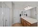 A bathroom features a double vanity, a separate shower, and tile flooring at 5656 Fast Payout Ct, Las Vegas, NV 89122