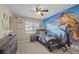 Well-lit bedroom with dinosaur-themed decor and dresser at 5656 Fast Payout Ct, Las Vegas, NV 89122