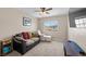 Bedroom with couch and ottoman, ceiling fan, and natural light from a window at 5656 Fast Payout Ct, Las Vegas, NV 89122