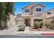 Beautiful two-story home with landscaped front yard, covered entry, and attached garage, offering curb appeal and convenience at 5656 Fast Payout Ct, Las Vegas, NV 89122