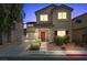 Charming two-story home featuring a well-maintained front yard, covered porch, and attached garage, perfect for Gathering living at 5656 Fast Payout Ct, Las Vegas, NV 89122