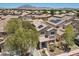 Two story home featuring a driveway, a mature tree, desert landscaping, and covered porch entryway at 5656 Fast Payout Ct, Las Vegas, NV 89122
